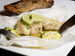 "Poisson En Papillote" with zucchini and onions.