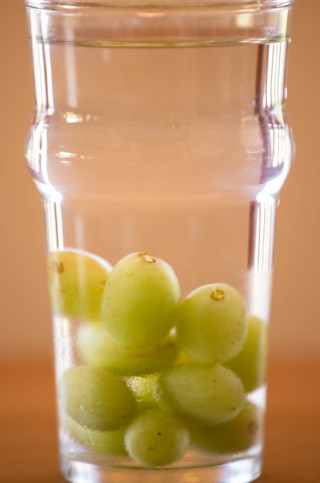 Frozen grapes chill'n my water.